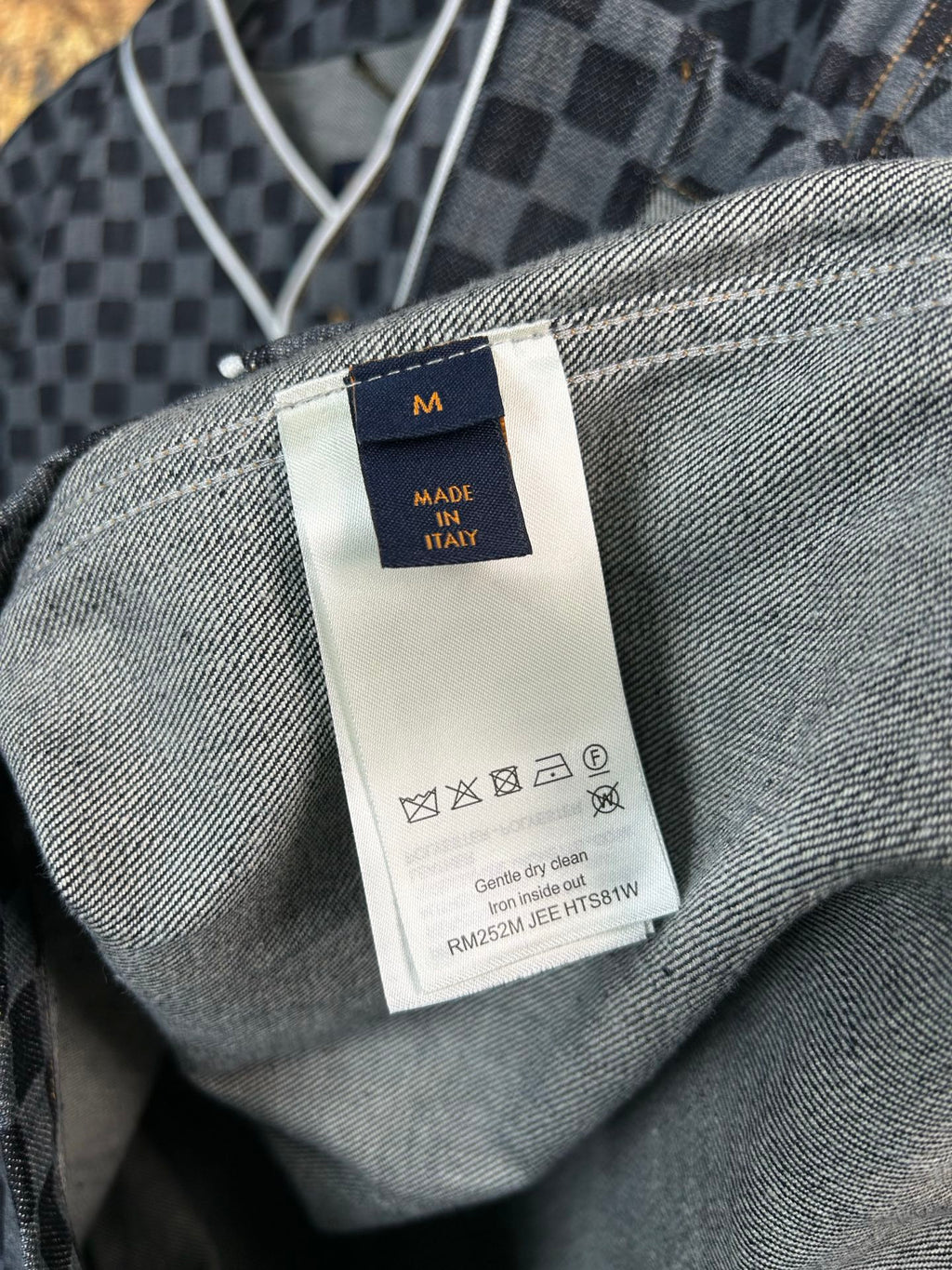 Size and care label on gray-and-black checkered shirt interior