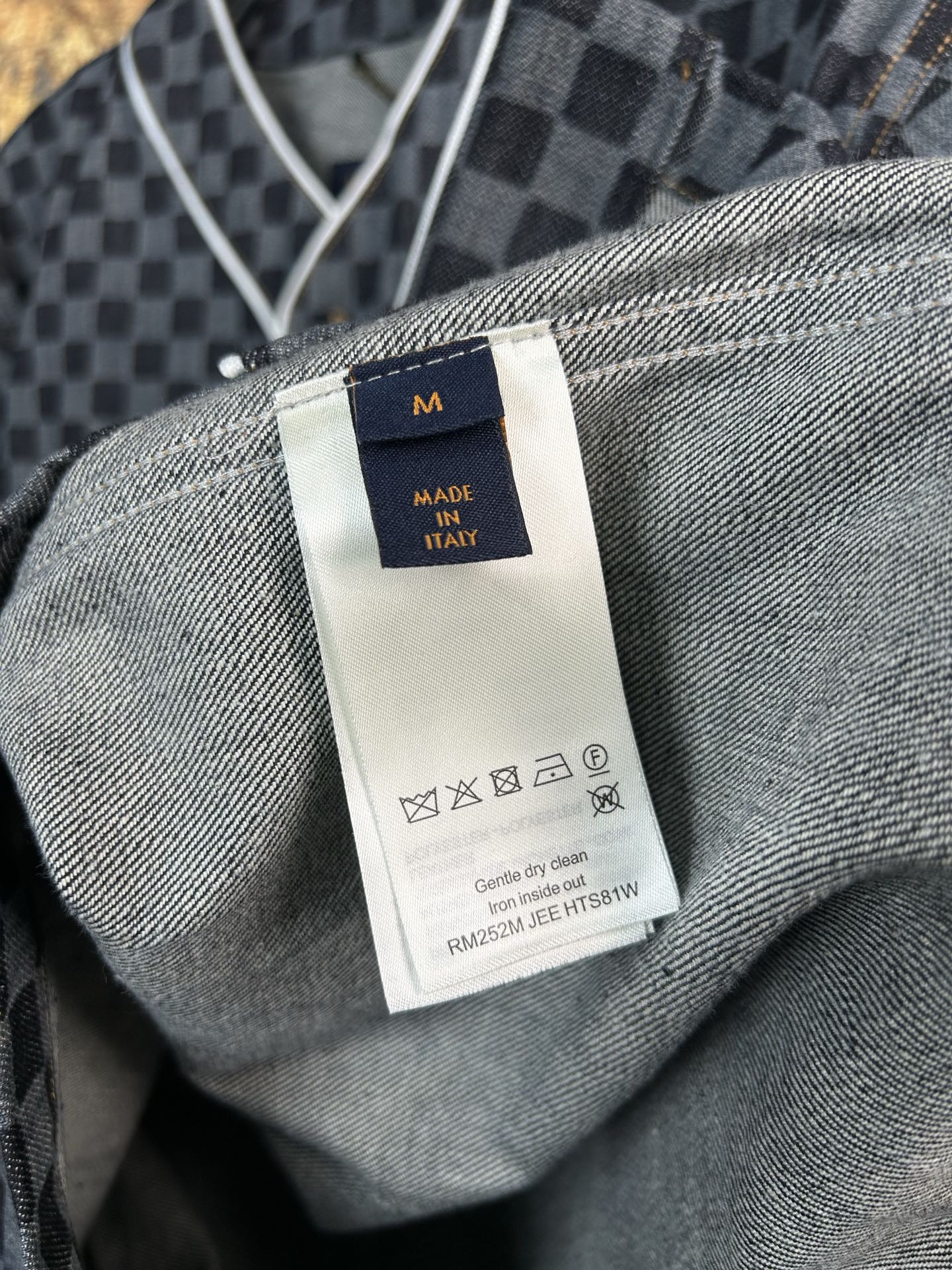 Size and care label on gray-and-black checkered shirt interior