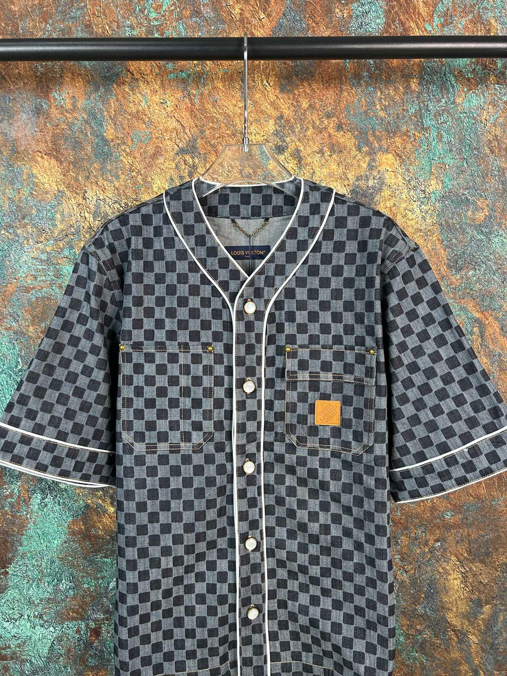 Checkered short-sleeve shirt with V-neck placket, chest pocket, and dark button front