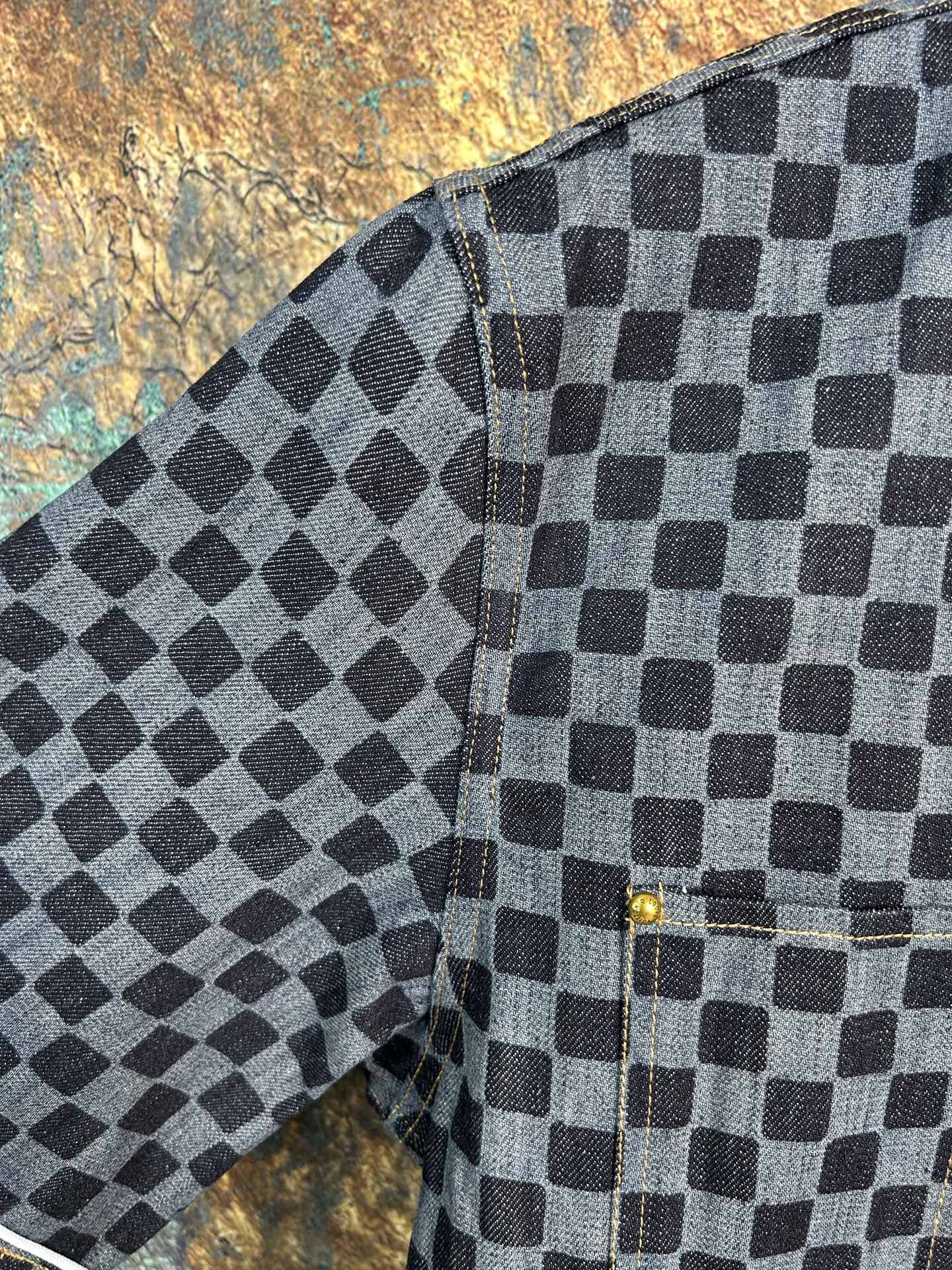 Checkered shirt sleeve and side seam detail with cuff stitching and dark buttons