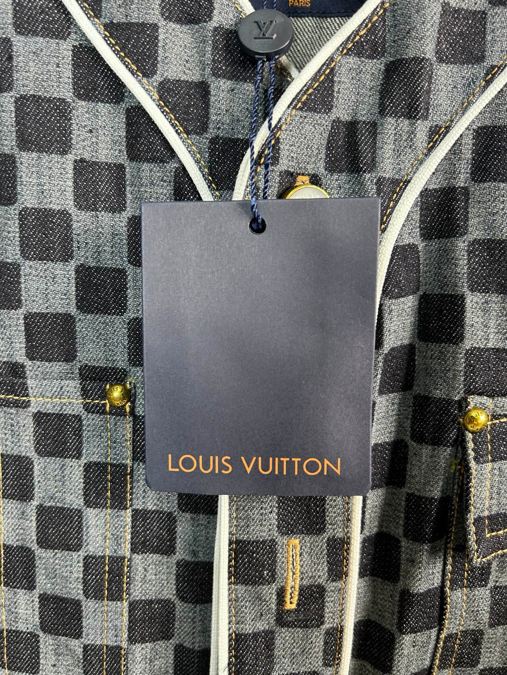 Louis Vuitton hangtag on checkered short-sleeve shirt with gold-tone snaps