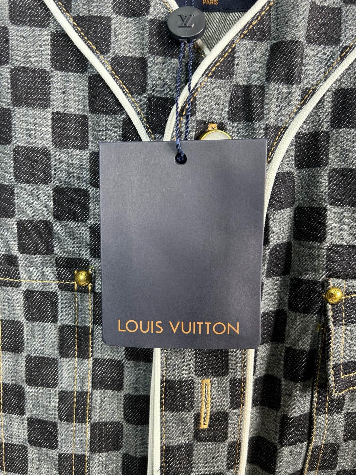 Louis Vuitton hangtag on checkered short-sleeve shirt with gold-tone snaps