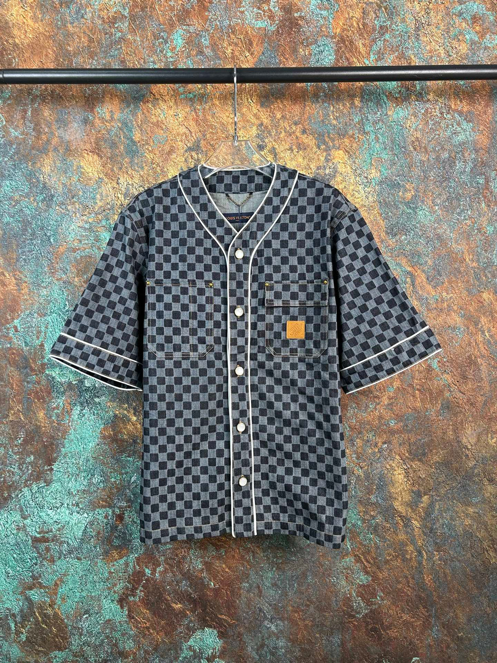 Checkered short-sleeve button-up shirt with dark trim and patch chest pocket