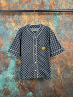Checkered short-sleeve button-up shirt with dark trim and patch chest pocket