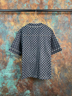 Checkered short-sleeve button-up shirt with striped cuffs and dark buttons