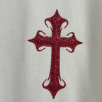 Red cross graphic on white T-shirt front