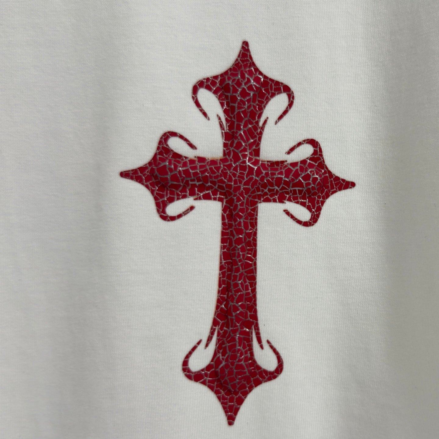 Red cross graphic on white T-shirt front
