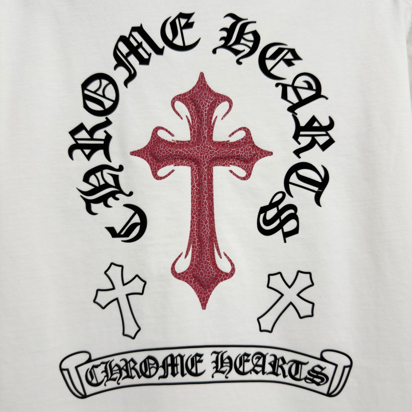 White T-shirt back with black Gothic text and red cross