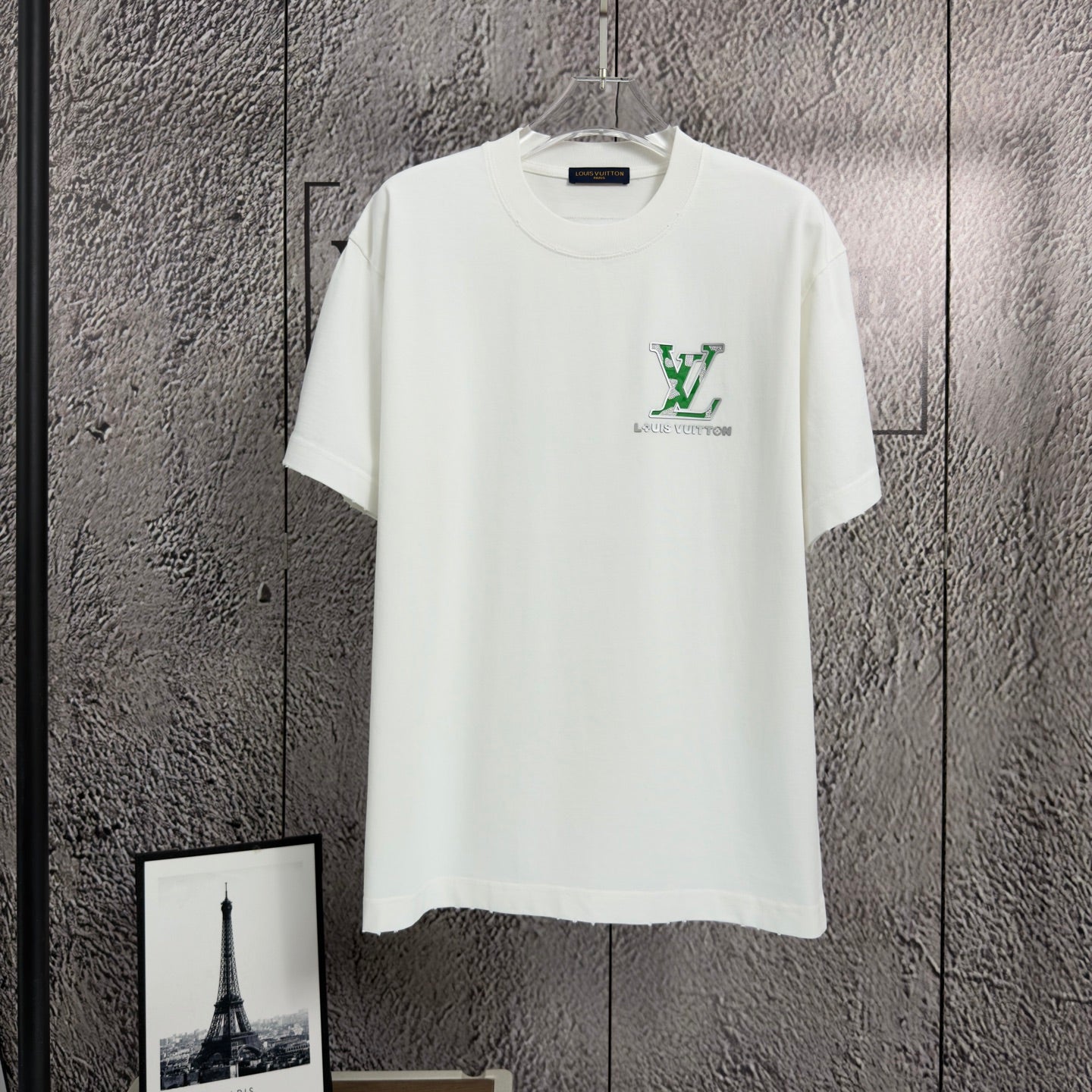White short-sleeve T-shirt with green logo graphic on front