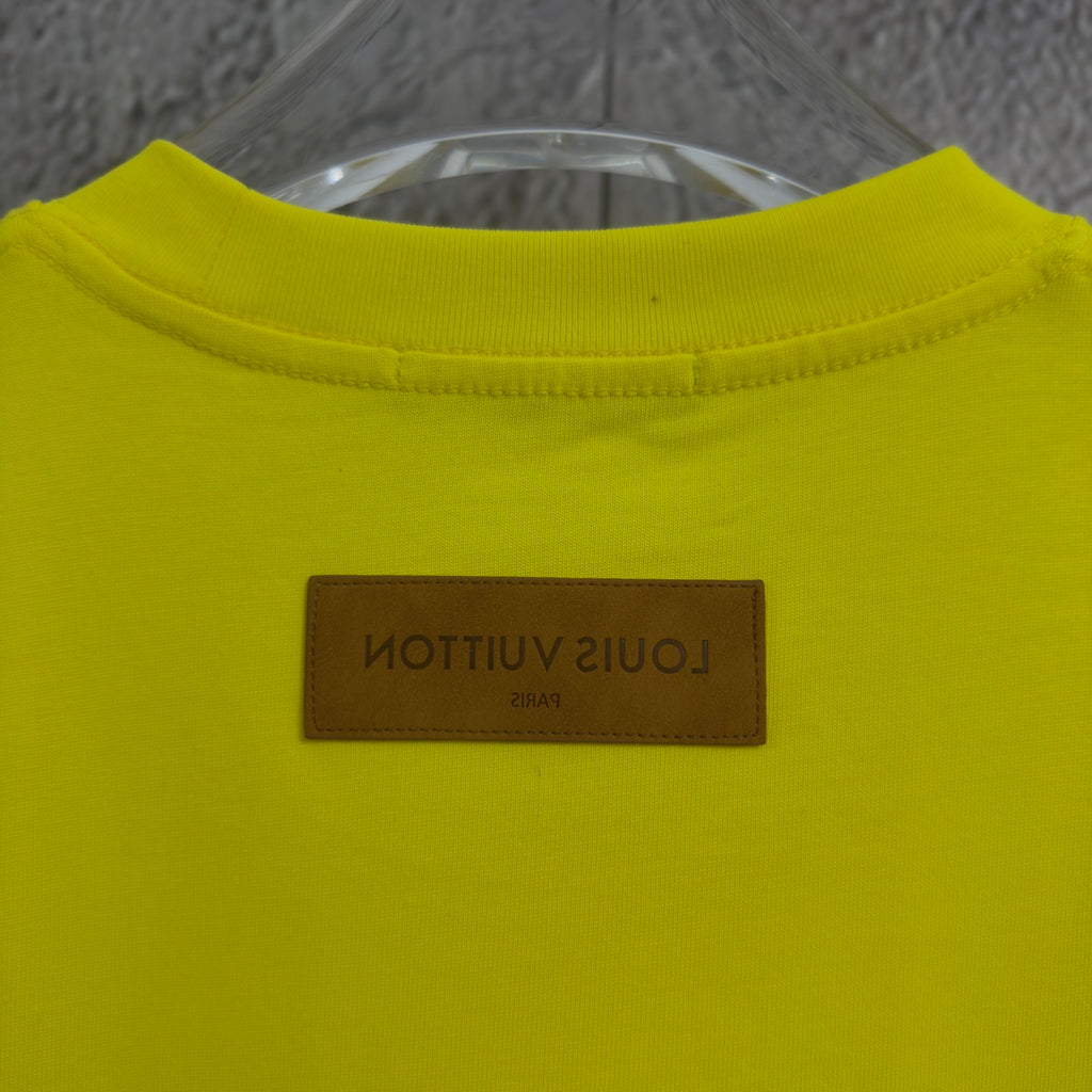 Louis Vuitton yellow T-shirt with brown brand label patch near collar