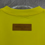 Louis Vuitton yellow T-shirt with brown brand label patch near collar