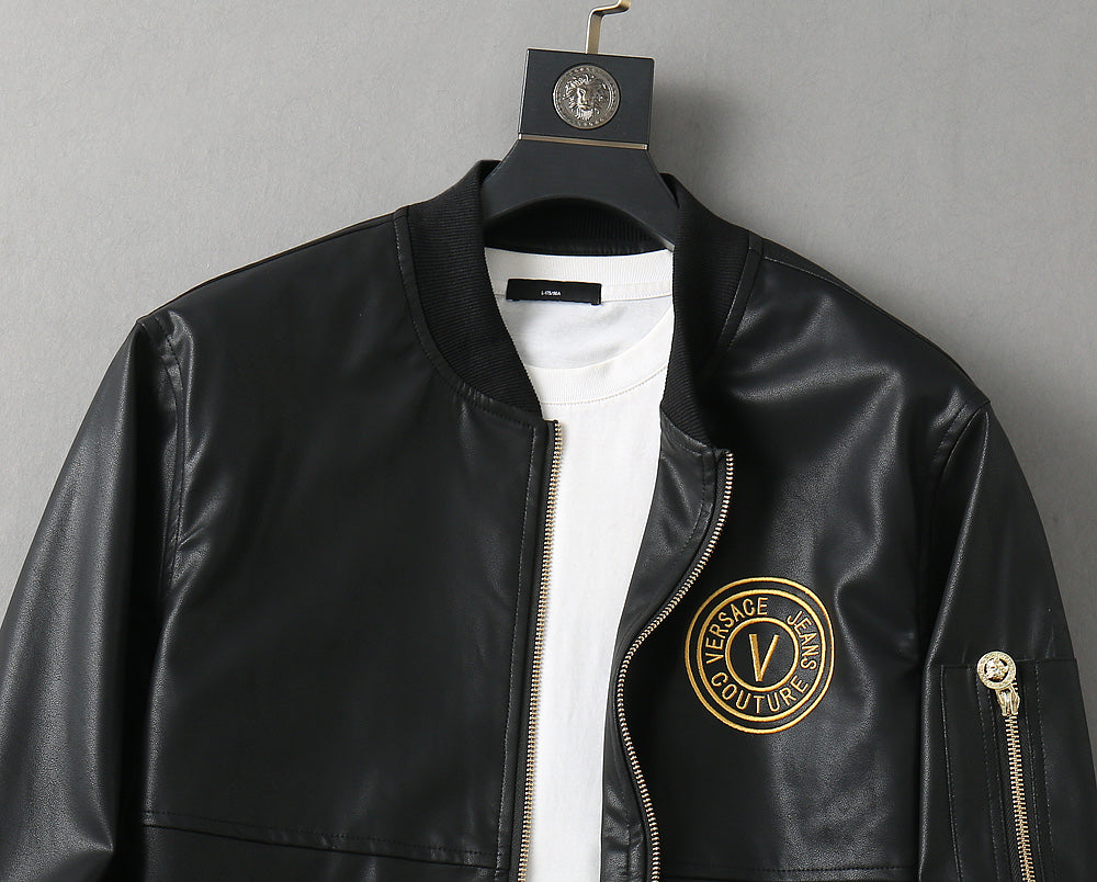 Black leather jacket front on hanger with white crew neck and gold logo patch