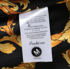 Printed fabric care tag on black and gold baroque lining inside the jacket