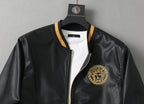 Black leather bomber jacket with gold-trimmed collar, front zipper, and chest logo