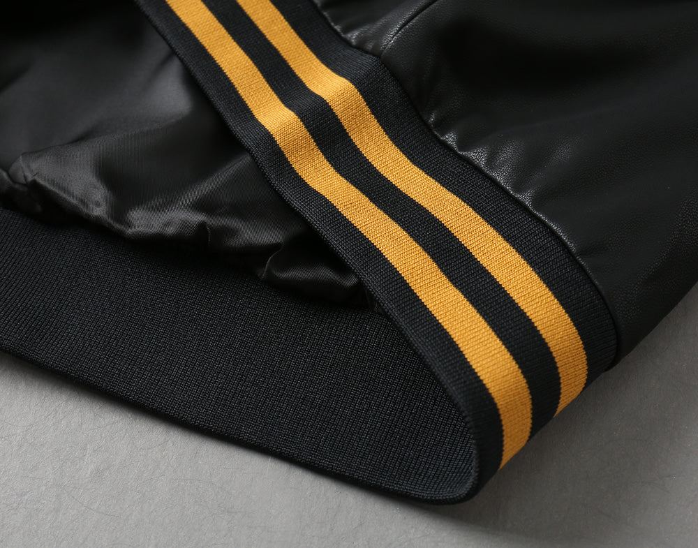 Black jacket sleeve cuff with two yellow and black striped bands