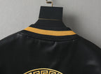 Black leather bomber jacket collar with ribbed knit and gold stripe trim