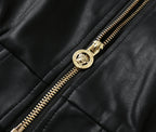 Black leather bomber jacket close-up of gold zipper and stitched seam