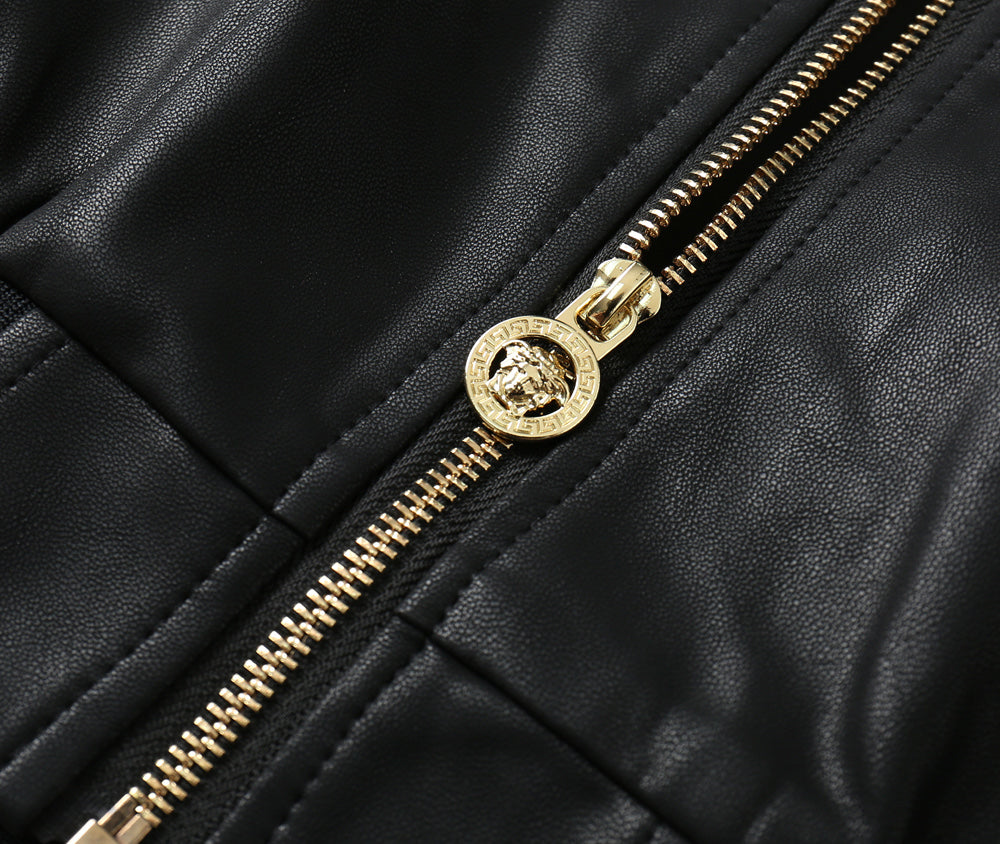Black leather bomber jacket close-up of gold zipper and stitched seam