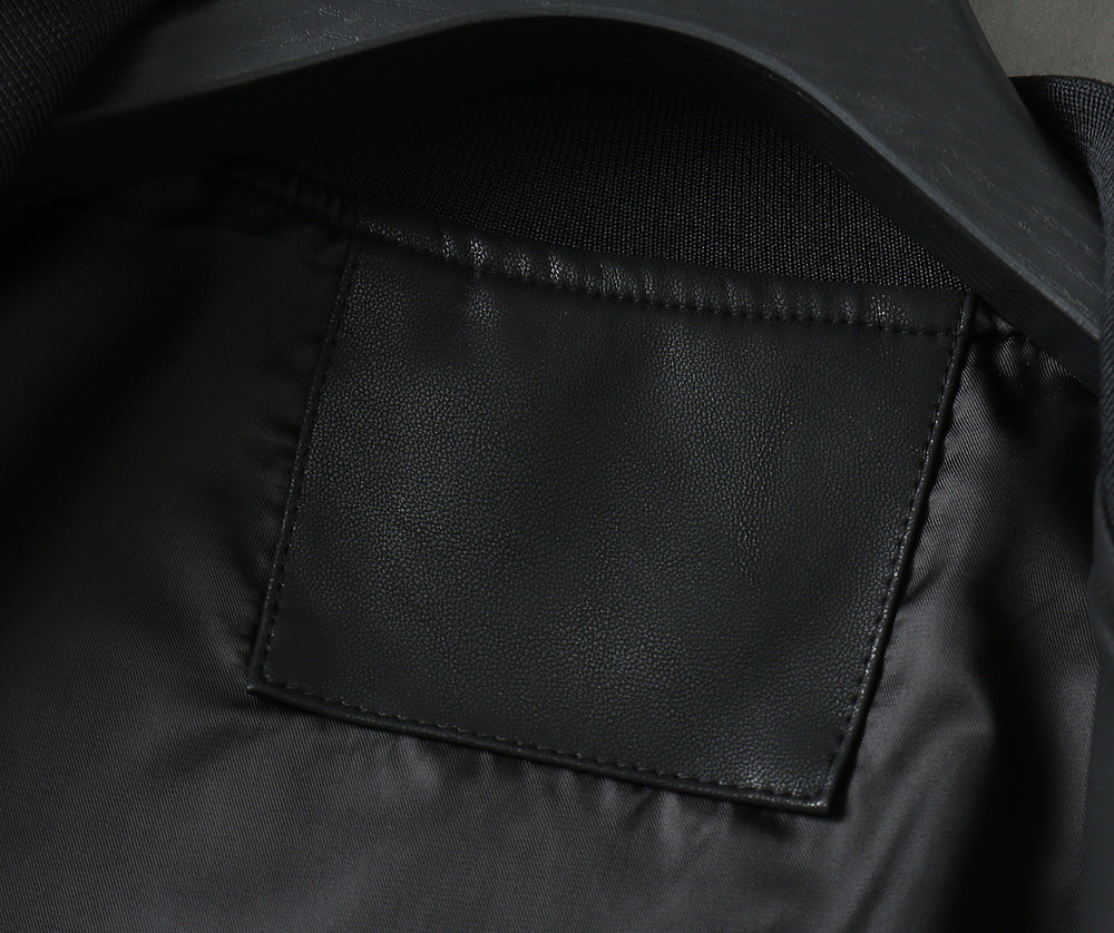 Black leather bomber jacket with visible interior patch pocket