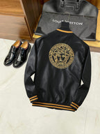 Black leather bomber jacket with large gold medallion logo on the back and ribbed cuffs