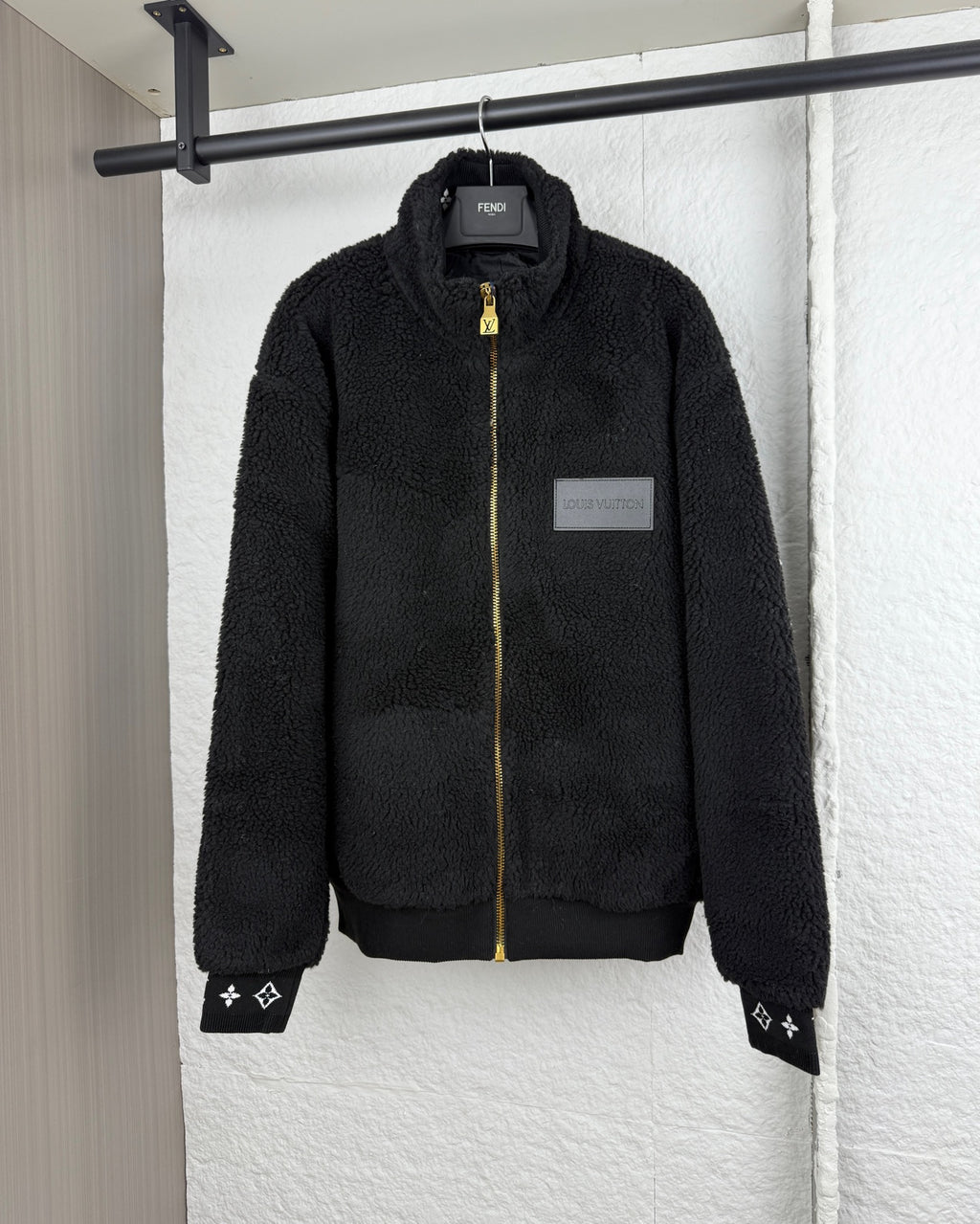 Black Louis Vuitton zip-up sherpa jacket with gold zipper and logo patch