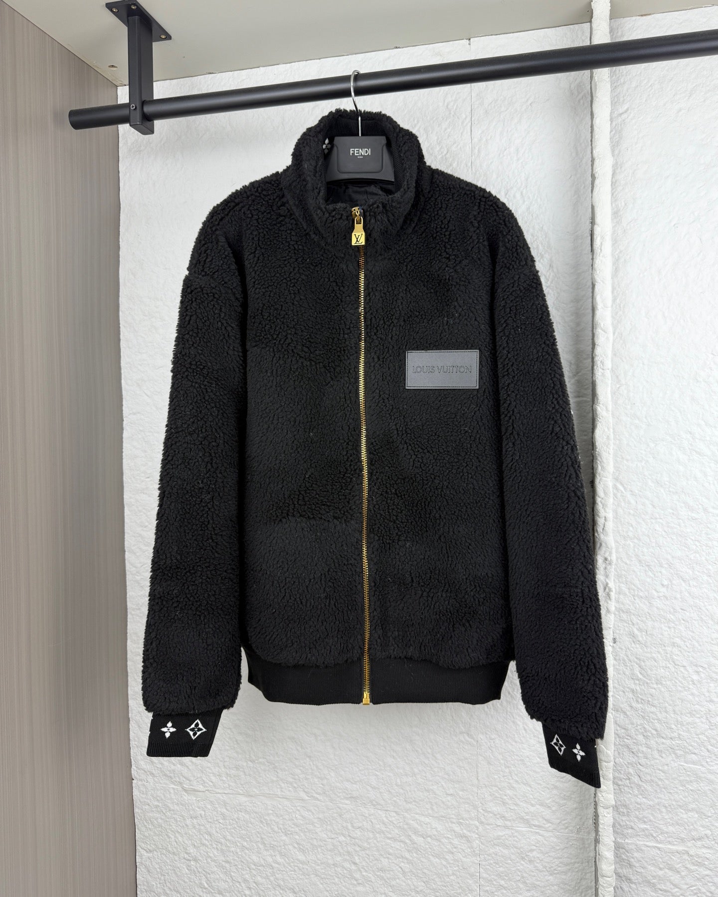 Black Louis Vuitton zip-up sherpa jacket with gold zipper and logo patch