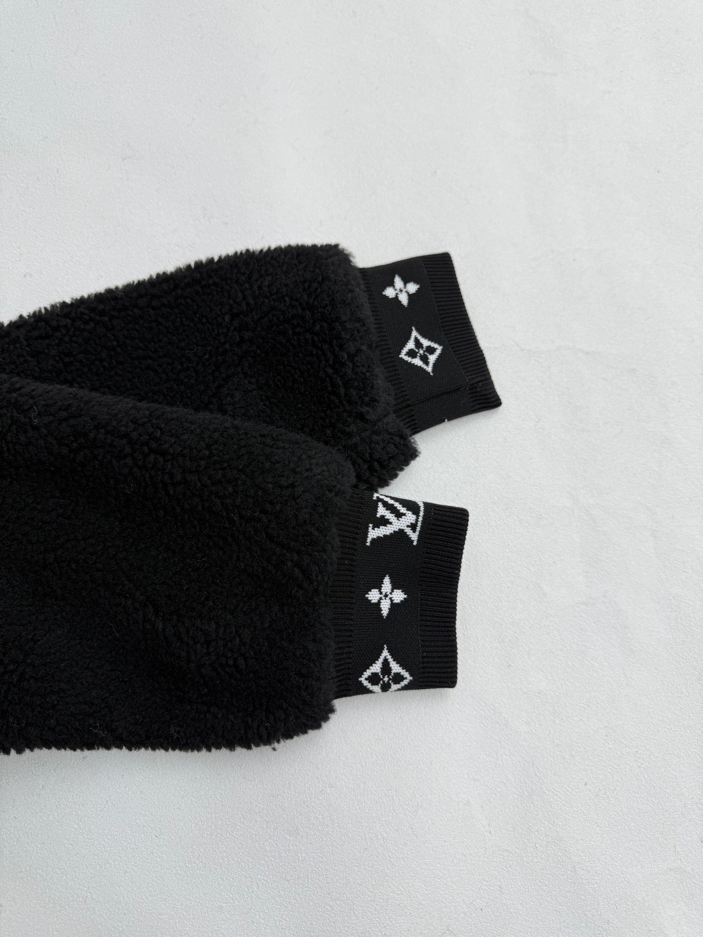 Black sherpa jacket cuffs with Louis Vuitton monogram band