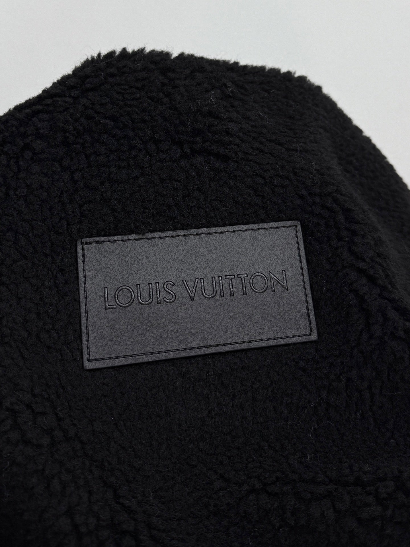 Black sherpa jacket with Louis Vuitton rectangular brand label