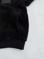 Black sherpa jacket sleeve with ribbed hem and embroidered cuff