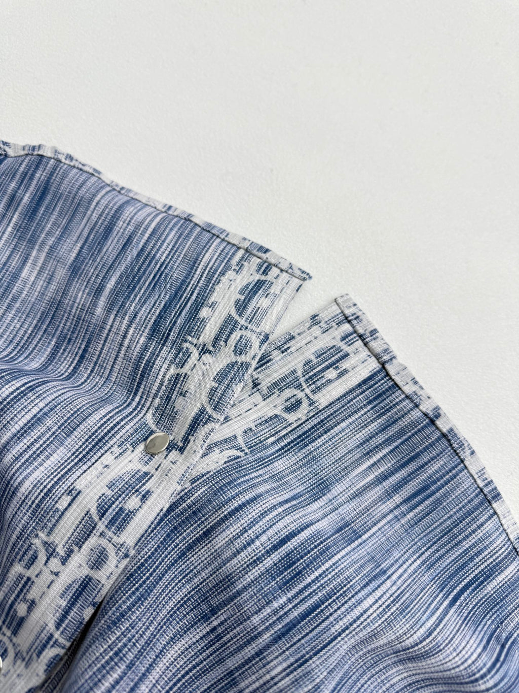 Blue and white Dior monogram sleeve with buttoned cuff
