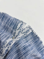 Blue and white Dior monogram sleeve with buttoned cuff