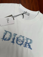 White crewneck T-shirt with blue Dior logo graphic and hanging label