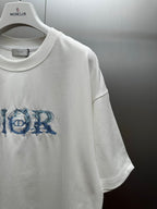 White short-sleeve crewneck T-shirt with blue Dior logo graphic on chest
