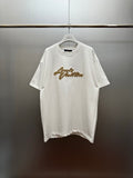 Louis Vuitton white short-sleeve shirt with gold embroidered script at chest