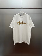 Louis Vuitton white short-sleeve shirt with gold embroidered script at chest