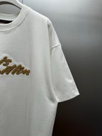 Louis Vuitton white short-sleeve shirt with gold logo detail on sleeve