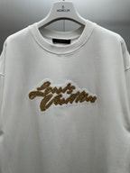 Louis Vuitton white short-sleeve shirt with gold embroidered script on chest