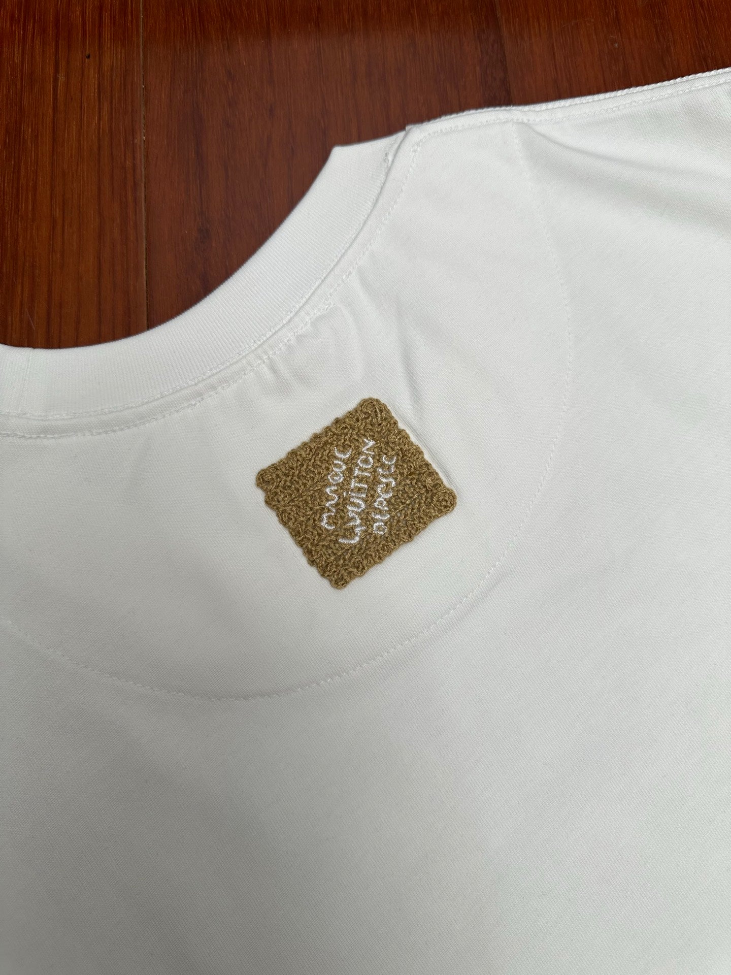 Louis Vuitton white short-sleeve shirt with gold square logo patch on chest