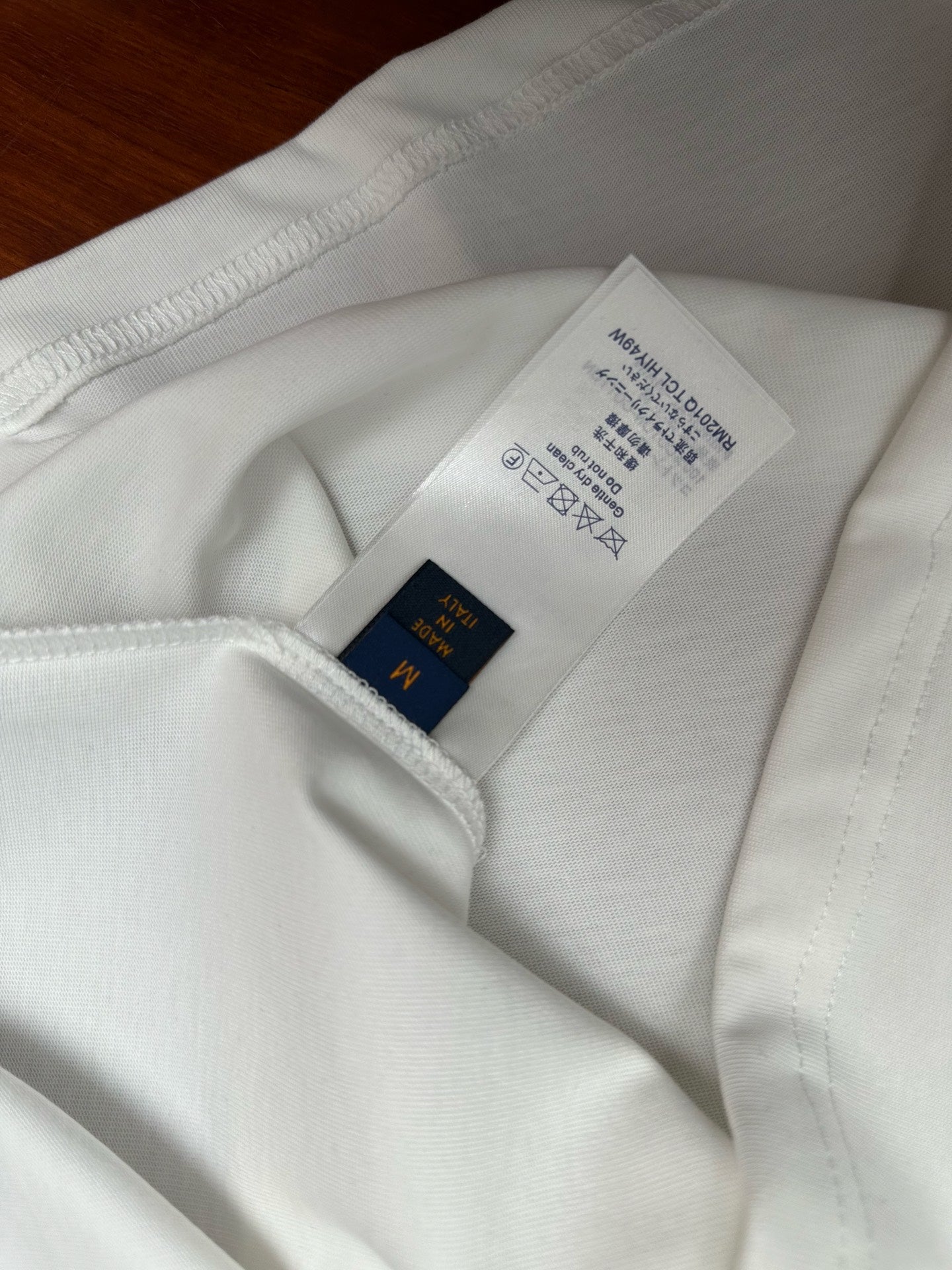 Louis Vuitton white short-sleeve shirt with size and care label at collar