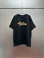 Louis Vuitton black short-sleeve T-shirt with gold script logo on the chest