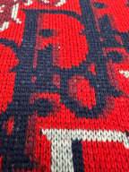 Dior knit fabric close-up: red, navy, and white logo pattern with ribbed edge