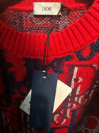 Dior knit sweater close-up: red, navy, and white logo knit with ribbed trim