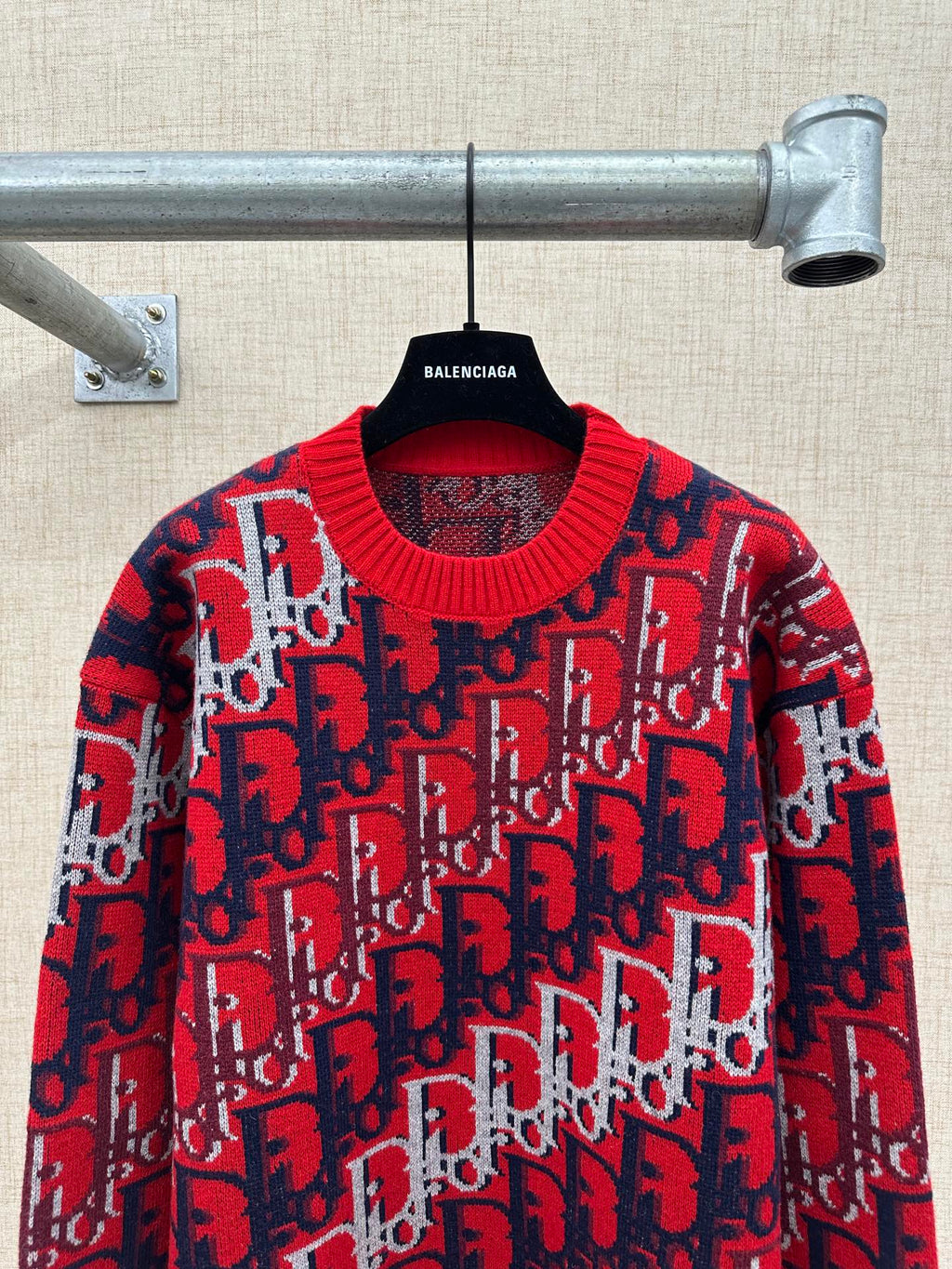 Dior knit sweater on hanger: red and navy logo knit with ribbed crew neck