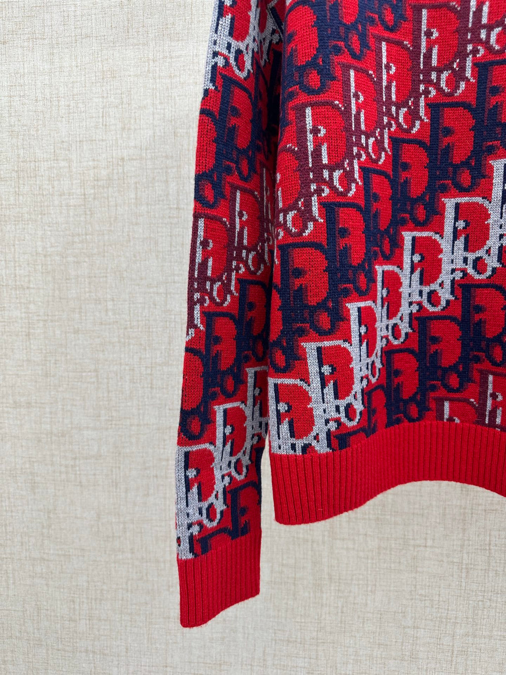 Dior knit sweater sleeve and hem, red and navy logo pattern with ribbed cuff