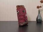 Burgundy mini bucket bag with gathered top, side hardware, and brown trim