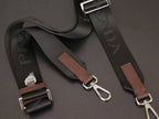 Brown leather and black webbing bag strap set with metal buckles.