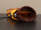 Prada bag interior view with brown fabric lining and drawstring edge.