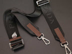 Prada bag strap set with brown leather tabs and silver metal hardware, detail view