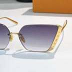 Close-up of gold-tone Louis Vuitton sunglasses with gradient purple lenses and temples