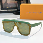 Green-tinted sunglasses with patterned frame and gold-tone rivets